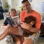 Rob Gronkowski Instagram - That’s my Momma @therealmommagronk instead of reading my elementary books to me, she is now reading her own book she wrote #outnumbered ! My mom is a beast who gets it done!! Grab a copy now on Amazon and learn about her amazing recipe’s and how she managed 5 Boys!! ❤️