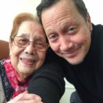 Rob Schneider Instagram - This incredible Filipina, my Tita Rose Formoso has passed to join her brothers, Bill and John and her sisters Virginia and my mother Pilar. Rose was 96 years old. She loved to dance and never stopped. As you can clearly see, there’s a kindness in her eyes. Whenever you saw her or called her she would answer with, “What can I do for you, my dear?” Every time I saw her, as a small child or as an adult, she made me feel happy and loved. That she survived the war and the Japanese occupation of the Philippines was a miracle. But for me the real miracle is that she was able to forgive and like my mother held no animosity against the Japanese who killed her brothers. When I first visited the Philippines when I was 8 years old, Rose asked me, “Is there anything you want my dear?” Because I saw coconut trees, I said, “I want a coconut.” But in Manila at the time of the year there weren’t any coconuts. Rosie sent some one to go to a northern province and 2 days later… I got my coconut. When she first moved to the United States, I shared my small room with her. Like most Filipino people, Rose didn’t talk much about herself except when asked. Instead, they ask about you and celebrate in any and all of your accomplishments, no matter how small. For our family, Rose was the last bridge to that era. I hope the people who read this could help pass on that Tita Rose tradition of kindness in their own families with her simple greeting, “What can I do for you, my dear?” That Rose is now with her Lord and Savior, Jesus Christ, whom she prayed to every night of her life, brings peace to all of our family. I send my love to ALL my cousins, her beautiful children, her Grandchildren and Rosie’s Great Grandchildren. May God Bless you and your families this day as well! With Salamat and Love, Robbie
