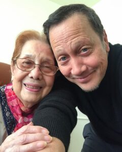 Rob Schneider Instagram - This incredible Filipina, my Tita Rose Formoso has passed to join her brothers, Bill and John and her sisters Virginia and my mother Pilar. Rose was 96 years old. She loved to dance and never stopped. As you can clearly see, there’s a kindness in her eyes. Whenever you saw her or called her she would answer with, “What can I do for you, my dear?” Every time I saw her, as a small child or as an adult, she made me feel happy and loved. That she survived the war and the Japanese occupation of the Philippines was a miracle. But for me the real miracle is that she was able to forgive and like my mother held no animosity against the Japanese who killed her brothers. When I first visited the Philippines when I was 8 years old, Rose asked me, “Is there anything you want my dear?” Because I saw coconut trees, I said, “I want a coconut.” But in Manila at the time of the year there weren’t any coconuts. Rosie sent some one to go to a northern province and 2 days later… I got my coconut. When she first moved to the United States, I shared my small room with her. Like most Filipino people, Rose didn’t talk much about herself except when asked. Instead, they ask about you and celebrate in any and all of your accomplishments, no matter how small. For our family, Rose was the last bridge to that era. I hope the people who read this could help pass on that Tita Rose tradition of kindness in their own families with her simple greeting, “What can I do for you, my dear?” That Rose is now with her Lord and Savior, Jesus Christ, whom she prayed to every night of her life, brings peace to all of our family. I send my love to ALL my cousins, her beautiful children, her Grandchildren and Rosie’s Great Grandchildren. May God Bless you and your families this day as well! With Salamat and Love, Robbie
