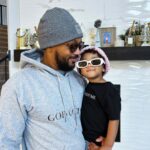 Romeo Miller Instagram - Just at the crib trying on the new @romeeverything threads for the relaunch this holiday season and my little River Rose saw the baby gear and dressed up like daddy, went and grabbed her shades and crashed the party and never left my side. Guess I found my new R|E model lol. Man I love being a girl dad! 🥹😎🤍💕 #GodGotMe #RomeEverything #LinkinBio #GirlDad #Twin