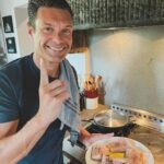 Ryan Seacrest Instagram - I love sea bass in the summer. It’s simple and a great opportunity to use quality extra virgin olive oil 🫒 Step 1 Put a little olive oil, salt, pepper, and herbs on the raw fish Step 2 Separately cook some summer tomatoes with sage, basil, garlic, and olive oil in a pan Step 3 Heat the pan. I use grapeseed oil when pan frying due to its high smoke point and its clean taste. Cook the fish skin side down until it’s cooked through (I like the skin golden brown and crispy) and add minced garlic. Step 4 Add some lemon and fresh EVOO on top and enjoy!