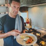 Ryan Seacrest Instagram - I love sea bass in the summer. It’s simple and a great opportunity to use quality extra virgin olive oil 🫒 Step 1 Put a little olive oil, salt, pepper, and herbs on the raw fish Step 2 Separately cook some summer tomatoes with sage, basil, garlic, and olive oil in a pan Step 3 Heat the pan. I use grapeseed oil when pan frying due to its high smoke point and its clean taste. Cook the fish skin side down until it’s cooked through (I like the skin golden brown and crispy) and add minced garlic. Step 4 Add some lemon and fresh EVOO on top and enjoy!