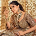 Sakshi Agarwal Instagram - “Draped in golden elegance, my sparkle matches the twinkle in my eyes. ✨ #GoldenLehengaMagic” . Jewellery : @challani_jewellery Hmua: @murugeshmakeup_hair @shalini_hairartist Location: @crowneplazachn Designer: @dvasabyabhi