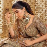 Sakshi Agarwal Instagram - “Draped in golden elegance, my sparkle matches the twinkle in my eyes. ✨ #GoldenLehengaMagic” . Jewellery : @challani_jewellery Hmua: @murugeshmakeup_hair @shalini_hairartist Location: @crowneplazachn Designer: @dvasabyabhi