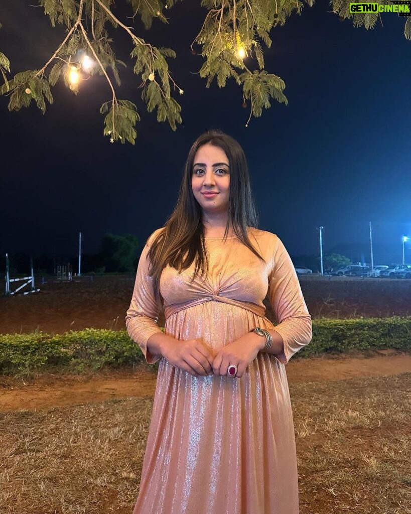 Sanjjanaa Instagram - This maternity friendly gold beautiful dress from India's number one maternity brand, @momzjoy , is truly stunning and looks absolutely stunning on me ! This dress has been specifically designed to cater to the needs of pregnant women & also goes very well on voluptuous woman like me, ensuring both comfort and style . the dress is designed with a maternity-friendly silhouette. It takes into consideration the changes that occur in a woman's body during pregnancy, such as a growing belly and fluctuating bust size. The dress provides ample room for your bump to grow comfortably, allowing you to move freely without any constraints and also most importantly, it is feeding friendly once your infant arrives. Additionally, the fabric used in this dress is carefully selected to ensure utmost comfort. It is soft, breathable, and stretchy, providing a gentle embrace to our changing body . The design of the dress is both fashionable and functional. It may feature a wrap-style front, or an empire waistline, all of which accentuate to woman’s beautiful curves and create a flattering silhouette. The dress may also include discreet nursing access, allowing you to breastfeed your baby conveniently while maintaining your style. As India's number one maternity brand, Momzjoy prioritizes the needs and desires of pregnant women, ensuring that their clothing not only meets the highest quality standards but also reflects the latest fashion trends. Their attention to detail and commitment to creating maternity-friendly designs is evident in this gold beautiful dress. Overall, this maternity dress from Momzjoy is a perfect choice, combining the elegance of gold with the comfort and functionality required during pregnancy. You can confidently wear this dress for various occasions, whether it's a special event, a party, or a casual outing, knowing that you look absolutely stunning and feel comfortable at the same time. - @sanjjanaagalrani Karnataka, Bangalore