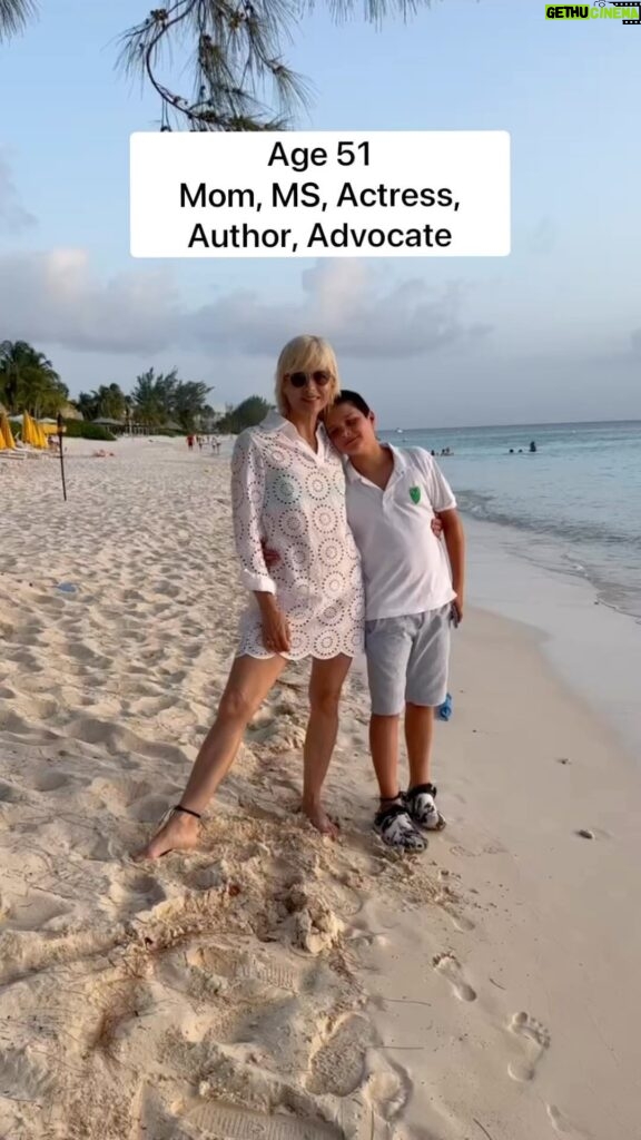 Selma Blair Instagram - Today is International Day of Persons with Disabilities. Thank you to this community. I’m proud to celebrate all of us today and every day. 💛 #IDPWD Video Description: Selma with short blonde hair wearing a white dress, is standing on a beach with her arm around her son Arthur. The video cuts to a series of clips of Selma on fashion shoots, traveling, and dancing. The text on the video reads: Age 51. Mom, MS, Actress, Author, Advocate.
