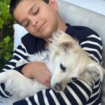 Selma Blair Instagram - My Saint, Arthur, happy birthday 🎂. This has been the most incredible life with you. Forever my favorite, I know you are going to have the best year yet. I am so proud of who you are and have become. Usually 🦁. The most adorable little kid has grown into a 12 year old!!!! 🐣🦅. I love you and I like you. Massively. 💛 mom Image descriptions: 1. A younger Arthur sits inside a brown handbag next to Selma while both look at the camera. They are poolside. 2. A 12-year old Arthur with short hair sitting on his motorbike and looking at camera. 3. Selma and Arthur wearing blue and white striped shirts sitting next to each other and looking at camera. 4. Arthur and Jason are on a boat with the sun and ocean behind them. They are smiling and looking at camera. 5. Selma, Arthur, and her dog Scout laying in bed. 6. Arthur in a striped sweater cuddles their dog Pippa. 7. An older photo of Selma and Arthur. Selma has long hair and they are smiling at the camera. 8. Selma and Arthur sit in bed. Selma is looking at Arthur and Arthur is looking into the distance. 9. Arthur in a blue shirt and short hair cuddles their dog Scout. 10. A younger Arthur with wild hair holding a guitar and smiling at camera.