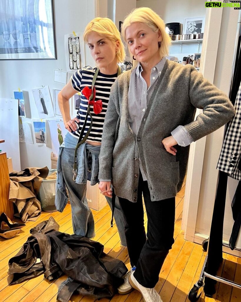 Selma Blair Instagram - You are my slay of the day every day @hodakotb and @jennabhager ! Thank you for having me on @hodaandjenna to talk Mean Baby! 📖💗 Image Descriptions: Image 1: Selma has short blonde hair and is standing on the left in a cream jacket and skirt. Hoda is in the middle in a yellow jacket with her arm around Selma. Jenna is on the right holding a cup of coffee wearing an orange skirt and top. Image 2: Selma getting her makeup touched up by Frankie. Selma is wearing a white robe with clips in her hair. Rita is in the background of the two. Image 3: Selma stands with Kate Young. Selma is wearing a striped shirt and jeans. Kate wears a grey sweater and black pants. Image 4: Selma stands in a matching cream skirt set, sunglasses, and black heels. Kate young is adjusting her outfit. Video: Selma walking into set with her dog, Scout. Selma greets Hoda and Jenna with hugs. Image 5: Selma sits in her robe and smiles to the camera.