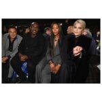 Selma Blair Instagram - The evening of Burberry. 🗡️ Image Descriptions: Image one: Selma has short blonde hair and wears a long black velvet coat. She is standing on the runway at the Burberry show with her cane with one hand in her pocket. Image two: Selma stands in front of orange wall. Image three: Selma sits with Edward and Naomi. Edward is wearing all black and Naomi is wearing a grey suit. Image four: Selma and Georgia are standing and both wearing black. Image five: Selma is standing in profile wearing a white robe while getting her hair done. Image six: Selma leans against an orange wall and is looking to the left.
