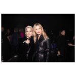 Selma Blair Instagram - The evening of Burberry. 🗡️ Image Descriptions: Image one: Selma has short blonde hair and wears a long black velvet coat. She is standing on the runway at the Burberry show with her cane with one hand in her pocket. Image two: Selma stands in front of orange wall. Image three: Selma sits with Edward and Naomi. Edward is wearing all black and Naomi is wearing a grey suit. Image four: Selma and Georgia are standing and both wearing black. Image five: Selma is standing in profile wearing a white robe while getting her hair done. Image six: Selma leans against an orange wall and is looking to the left.
