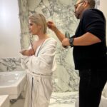 Selma Blair Instagram - The evening of Burberry. 🗡️ Image Descriptions: Image one: Selma has short blonde hair and wears a long black velvet coat. She is standing on the runway at the Burberry show with her cane with one hand in her pocket. Image two: Selma stands in front of orange wall. Image three: Selma sits with Edward and Naomi. Edward is wearing all black and Naomi is wearing a grey suit. Image four: Selma and Georgia are standing and both wearing black. Image five: Selma is standing in profile wearing a white robe while getting her hair done. Image six: Selma leans against an orange wall and is looking to the left.