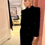 Selma Blair Instagram - The evening of Burberry. 🗡️ Image Descriptions: Image one: Selma has short blonde hair and wears a long black velvet coat. She is standing on the runway at the Burberry show with her cane with one hand in her pocket. Image two: Selma stands in front of orange wall. Image three: Selma sits with Edward and Naomi. Edward is wearing all black and Naomi is wearing a grey suit. Image four: Selma and Georgia are standing and both wearing black. Image five: Selma is standing in profile wearing a white robe while getting her hair done. Image six: Selma leans against an orange wall and is looking to the left.