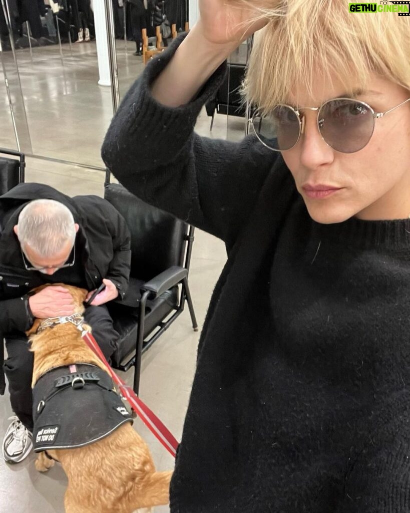 Selma Blair Instagram - 🤍🗽 Image Descriptions: 1. Selma has short blonde hair and is sitting on brick balcony wearing a grey coat with black collar. 2. Black/white photo of Selma and Christian Siriano at dinner. Christian has short dark hair and is wearing a black tshirt. 3. Selma is wearing a black sweater and sunglasses. A man is seated behind her playing with her dog Scout. 4. Black/white photo of Selma, Art Tavee and Carolyn Griffin at dinner. Art has short light hair and wears glasses and Carolyn has shoulder length hair. 5. Selma, Troy, Art, and Carolyn posing together for a selfie outside at dinner. 6. Selma posing in the mirror in a hotel bathroom. There are pink flowers in the focus of the photo. She wears a black sweater with a white collared shirt under it. New York, New York