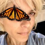 Selma Blair Instagram - I have assigned meaning before their due, searching past reason. But I believe in Transformation. And the reality of the butterfly. And that it has kept me company all afternoon. And still even now. Things are changing 👸 [Image and Video Descriptions: 1. Selma has short blonde hair and has a butterfly covering one eye. 2. The butterfly rests on the back of Selma’s head. 3. Video of Selma outside wearing a blue shirt with white stripes while speaking to the camera with a butterfly on her head.]