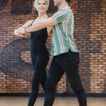 Selma Blair Instagram - Oh the places I’ve been! But I never considered I would be in a dance rehearsal space for a live @disneyplus ballroom dance show. And I loved every single second of it. Having an “atta girl” from so many people in my life and on here and in the @dancingwiththestars 🪩 world has changed me for the better. And always to @sashafarber1 for being my first and only partner. All love. 💜 thank you @arttavee for always holding me in frame as well. I love you 📷 Series of images of Selma and Sasha in both color and black and white in a dance studio. Selma has short blonde hair and is wearing a black bodysuit. Sasha has short dark hair and is wearing a striped shirt in some images and no shirt in others. Selma’s dog Scout is in the third image on the right in the photo.