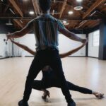 Selma Blair Instagram - Oh the places I’ve been! But I never considered I would be in a dance rehearsal space for a live @disneyplus ballroom dance show. And I loved every single second of it. Having an “atta girl” from so many people in my life and on here and in the @dancingwiththestars 🪩 world has changed me for the better. And always to @sashafarber1 for being my first and only partner. All love. 💜 thank you @arttavee for always holding me in frame as well. I love you 📷 Series of images of Selma and Sasha in both color and black and white in a dance studio. Selma has short blonde hair and is wearing a black bodysuit. Sasha has short dark hair and is wearing a striped shirt in some images and no shirt in others. Selma’s dog Scout is in the third image on the right in the photo.