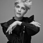 Selma Blair Instagram - “In the meantime, I took a job folding T-shirts at the Gap on Seventy-Fifth and Lex. I loved folding clothes on the folding board. I loved the Gap pens we won if we sold the most product that day. I loved the employee discount and the tap of the register keys as I printed out gift certificates and ran exchanges. In a way, working at the Gap was the perfect job for me, a place to channel my deep need for organization.” — Excerpt from Mean Baby Image one: Selma has short blonde hair, is wearing a black shirt and is resting her chin on the handle of her cane looking off to the right. Image two: Selma has short blonde hair, is wearing a black shirt and holding her cane in her right hand as her whole body is facing right. Image three: Selma is wearing black jeans, shirt and shoes while she is jumping above her cane, which she is holding in her right hand. Image four: Selma is on set wearing a jacket. Her right knee is bent as she looks directly at the camera. Image five: Selma is seated and looking directly at the camera while she leans on her cane. Image six: Written text from Mean Baby.
