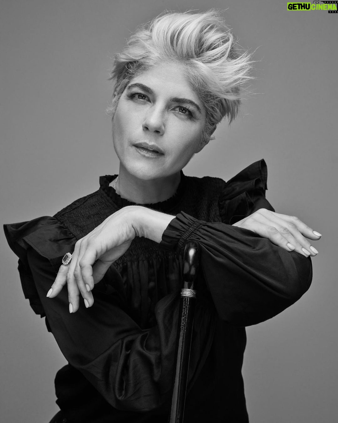 Selma Blair Instagram - “In the meantime, I took a job folding T-shirts at the Gap on Seventy-Fifth and Lex. I loved folding clothes on the folding board. I loved the Gap pens we won if we sold the most product that day. I loved the employee discount and the tap of the register keys as I printed out gift certificates and ran exchanges. In a way, working at the Gap was the perfect job for me, a place to channel my deep need for organization.” — Excerpt from Mean Baby Image one: Selma has short blonde hair, is wearing a black shirt and is resting her chin on the handle of her cane looking off to the right. Image two: Selma has short blonde hair, is wearing a black shirt and holding her cane in her right hand as her whole body is facing right. Image three: Selma is wearing black jeans, shirt and shoes while she is jumping above her cane, which she is holding in her right hand. Image four: Selma is on set wearing a jacket. Her right knee is bent as she looks directly at the camera. Image five: Selma is seated and looking directly at the camera while she leans on her cane. Image six: Written text from Mean Baby.
