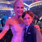 Selma Blair Instagram - About last night…💜 And all the love to @sashafarber1 and my crew of greats✨ IMAGE 1: Selma has short blonde hair and is being lead downstage into the spotlight by her partner Sasha who has short brown hair and is wearing a lavender suit. IMAGE 2 : Selma has short blonde hair and is seated in a chair in wearing a long lavender dress while she looks to the left and holds hands with Amy, who has dark blonde hair and is wearing black pants and a black top. IMAGE 3: Selma stands in a lavender dress with her friends Jamie, Andraéa, Hylda, her son Arthur and Jason. IMAGE 4: Selma has short blond hair and is standing with her arm around her son Arthur, who is wearing a navy jacket. IMAGE 5 - Selma and Sasha hug on stage at the end of their performance.