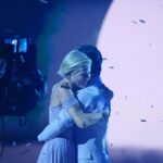 Selma Blair Instagram - About last night…💜 And all the love to @sashafarber1 and my crew of greats✨ IMAGE 1: Selma has short blonde hair and is being lead downstage into the spotlight by her partner Sasha who has short brown hair and is wearing a lavender suit. IMAGE 2 : Selma has short blonde hair and is seated in a chair in wearing a long lavender dress while she looks to the left and holds hands with Amy, who has dark blonde hair and is wearing black pants and a black top. IMAGE 3: Selma stands in a lavender dress with her friends Jamie, Andraéa, Hylda, her son Arthur and Jason. IMAGE 4: Selma has short blond hair and is standing with her arm around her son Arthur, who is wearing a navy jacket. IMAGE 5 - Selma and Sasha hug on stage at the end of their performance.