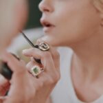 Selma Blair Instagram - Thank you @coveteur for highlighting my wellness journey 🤍 link in Stories Image 1: Selma has short blonde hair and is wearing a shiny black and bronze striped jacket. She has her hands lifted over head and face angled towards the camera, looking down. Her eye shadow is bronze and black. Image 2: Selma has short blonde hair and looks into a mirror as she holds a makeup tool for eyebrows from Guide Beauty Cosmetics. She wears a large emerald ring. Image 3: A headline from the Coveteur reads, “Selma Blair on Rediscovering Wellness Rituals That Work For Her.” Selma is quoted “now that I have cleared up some lost energy, I have the patience to witness my own imbalances.” Selma is shown sitting on a couch looking direct to camera.