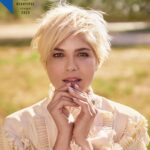 Selma Blair Instagram - “Good things will happen. And horrible things. And it will all be part of finding your footing and carrying on. You are worth loving.” To read more of my letter to my younger self, check out @people’s beautiful issue. Out now 💛 Image descriptions: Image 1: Selma has short blonde hair and wears a white blouse. Her hands are clasped in front of her mouth and she stands in a field of grass Image 2: Image of Selma as a young girl with long dark hair. She is smiling and wearing a black top with a white turtleneck under it. On the right is her sister Lizzie, who has long dark hair.