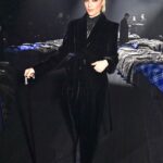 Selma Blair Instagram - The evening of Burberry. 🗡️ Image Descriptions: Image one: Selma has short blonde hair and wears a long black velvet coat. She is standing on the runway at the Burberry show with her cane with one hand in her pocket. Image two: Selma stands in front of orange wall. Image three: Selma sits with Edward and Naomi. Edward is wearing all black and Naomi is wearing a grey suit. Image four: Selma and Georgia are standing and both wearing black. Image five: Selma is standing in profile wearing a white robe while getting her hair done. Image six: Selma leans against an orange wall and is looking to the left.