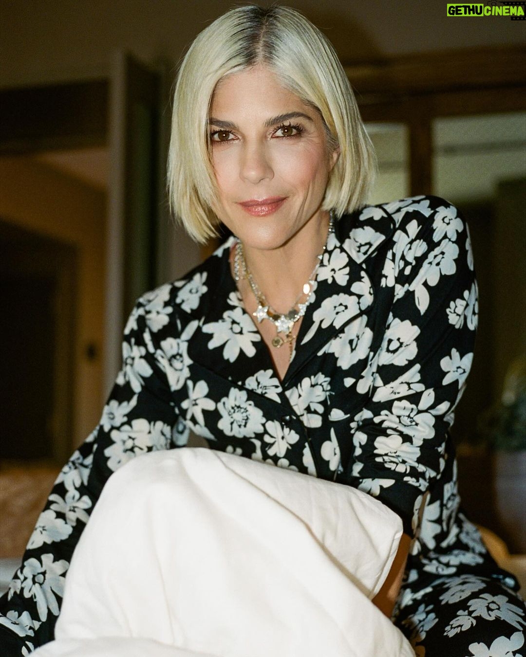 Selma Blair Instagram - NYC. Friday night. Room service. π Image Descriptions: 1) Selma with short blonde hair wearing a black and white floral PJ set, standing in a hotel bathroom and posing for the camera. 2) Selma standing on the bed with one leg up and both arms up. 3) Selma sitting on the bed and looking at the camera. 4) Selma midair with her legs crossed and hands up, looking to the side. 5) black and white photo of Selma kneeling next to Scout and smiling at the camera as he licks her face.