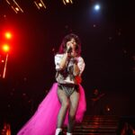 Shania Twain Instagram - We were ROCKIN’ in Buffalo 💥 I took inspiration from some of my favorite female punk rockers for my show outfit - @benatargiraldo, @blondieofficial, @heartofficial… edgy femininity. I just love the contrast of the pink tutu against the boots! Plus jumping around onstage is much easier in docs than heels!! 😂 Buffalo, New York