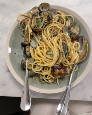 Stanley Tucci Instagram - Happy as a clam. ⠀
⠀
⠀
⠀
• 1 pound spaghetti ⠀
• 1 pound of clams (smaller the better)⠀
• handful of chopped parsley⠀
• 2 cloves of garlic roughly chopped ⠀
⠀
**serves 4 OR me and my wife⠀
⠀
- Put your clams in a bowl of very salty water for 20 minutes to purge them of any dirt. Discard any that are open before cooking. ⠀
⠀
- Put the pasta on to boil in salted water ⠀
⠀
- Place a large frying pan on a medium to high heat add a glug of extra virgin Olive oil.  throw in your garlic and cook for one minute until soft (move garlic around the pan to prevent it from burning)⠀
⠀
- Add your clams to the frying pan and turn heat to high. Cook until all or nearly all are open. ⠀
⠀
- Add your parsley ⠀
⠀
- Drain pasta reserving one cup of pasta water ⠀
⠀
- Add cooked pasta to the frying pan with half of the reserved pasta water and toss. (Add more water if it looks too dry)⠀
⠀
- Add salt and a splash of extra virgin olive oil to taste.