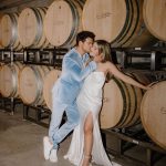 Taylor Lautner Instagram – WELCOME PARTY
Following rehearsal dinner, doors opened to the rest of the underground wine caves where we held a party to welcome all of our guests to Paso Robles for the weekend. Two black wooden bars, grey stoneware plates, charcoal tufted couches and loveseats, and gorgeous concrete and wooden starburst cocktail tables were additional details which enhanced the existing environment, and played into the underground winery aesthetic. We are true foodies at heart so we wanted to give guests an assortment of options to indulge in. This included 4 different food stations to satisfy every palate. A Mezze station, oyster and seafood bar, Tapas station and an Americana station. Our personal favorite was the chef carved Jamoń Iberico and chef manned raclette cheese melter. Complimenting the delicious food of course was Epoch’s killer wines. It truly was the most unique environment and best way to welcome all of our family and friends to a place that holds such a special spot in our hearts. 
Let the festivities begin! 

Planning and Event Design @samkoma.world 
Venue @epochwines 
Photography @nicoleivanovphoto 
Lighting @tn_event_designs