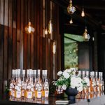 Taylor Lautner Instagram - COCKTAIL HOUR/RECEPTION After the ceremony, guests were shuttled back down from the vineyard to the tasting room where they toasted one another with a glass of Casamigos cocktails named after our dogs Remi and Lily, and a variety of wines from Epoch. Live music was played on a grand piano covered in overgrown florals, and bottles of Epoch’s Rose were being live painted for guests to take home at the end of the night as a keepsake. Hundreds of Edison bulbs hung from the stunning trees over the cocktail bar, grand piano and live bottle painting station. On their way to the reception area, guests walked through a butterfly garden filled with greenery. There, butterflies floated amongst guests while a harpist played in the background. Once inside, there were candles from Snif burning a custom scent called “Sweet Ash” and leather menu books embossed with a custom TT logo at each place setting. We both attach smells to memories and people so we wanted to have a specific “scent” to our wedding that guests walked away resonating it to. We felt including this unique logo of two T’s intertwined (designed by our planner/designer Josiah) on just about every part of the day would make it feel special. Greenery and white florals filled the room to contrast the sexy industrial look of the tasting room. Did someone say more Edison bulbs? Yes, we did. Hanging Edison bulbs lined the three rows of tables we had for our loved ones. After our three course dinner paired with Epoch’s wines concluded everyone was ushered back outside surrounding the grand piano where our good friend and boy Tay’s groomsmen Aodhan King performed our first dance live. Aodhan and our other close friend Ben Hastings were gracious enough to lend us their beautiful voices for a few more songs until it was time to party. Low flying dry ice fog started to escape under the tasting room doors to outside inviting people back into a completely flipped dance floor that would take our souls for the rest of the evening. What’s a wedding without a dance floor, a few spilled drinks and the brides mother actually taking a nasty spill on it ;) (true story, rip to her kneecaps) Epoch Estate Wines