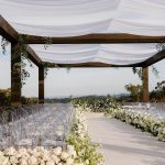 Taylor Lautner Instagram – CEREMONY
The ceremony was something we’ve been dreaming of for a long time. Along with the help of our wedding planners, we put in a lot of thought designing what exactly we wanted for this monumental moment and it came together even better than we had imagined. The ceremony location was at one of the highest points on the Epoch property which overlooks miles of wine country in Paso Robles. The colors surrounding us at this time of year are exactly why we love the Fall season so much. In an effort to provide shade and intimacy we installed a wooden truss system and semi sheer white draping, to create a relaxing and partially shaded ceremony location. White florals and lush greenery trailed up the columns of the wooden
structure and down the ceremony aisle. Beautiful white floral blooms surrounded us on a circle riser stage. As guests arrived by shuttle, they were invited to take a walk through the vineyard to the ceremony site. Our pastor and dear friend Judah Smith officiated the ceremony. It couldn’t have been more perfect. We exchanged hand written vows in front of the people we love most. Looking around and seeing the faces of each and every single person there, really put into perspective what is most important in life. Love. The sun set just as we said our “I Do’s” and the most beautiful pink sky was our backdrop as we walked back down the aisle as Mr. and Mrs. Taylor Lautner for the first time.
Planning and Event Design @samkoma.world
Venue @epochwines
Photography @nicoleivanovphoto
Lighting @tn_event_designs
Floral Design @noonansdesigns
Wedding Dress @winniecouture
Grooms Tux @dolcegabbana