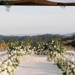 Taylor Lautner Instagram – CEREMONY
The ceremony was something we’ve been dreaming of for a long time. Along with the help of our wedding planners, we put in a lot of thought designing what exactly we wanted for this monumental moment and it came together even better than we had imagined. The ceremony location was at one of the highest points on the Epoch property which overlooks miles of wine country in Paso Robles. The colors surrounding us at this time of year are exactly why we love the Fall season so much. In an effort to provide shade and intimacy we installed a wooden truss system and semi sheer white draping, to create a relaxing and partially shaded ceremony location. White florals and lush greenery trailed up the columns of the wooden
structure and down the ceremony aisle. Beautiful white floral blooms surrounded us on a circle riser stage. As guests arrived by shuttle, they were invited to take a walk through the vineyard to the ceremony site. Our pastor and dear friend Judah Smith officiated the ceremony. It couldn’t have been more perfect. We exchanged hand written vows in front of the people we love most. Looking around and seeing the faces of each and every single person there, really put into perspective what is most important in life. Love. The sun set just as we said our “I Do’s” and the most beautiful pink sky was our backdrop as we walked back down the aisle as Mr. and Mrs. Taylor Lautner for the first time.
Planning and Event Design @samkoma.world
Venue @epochwines
Photography @nicoleivanovphoto
Lighting @tn_event_designs
Floral Design @noonansdesigns
Wedding Dress @winniecouture
Grooms Tux @dolcegabbana