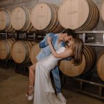 Taylor Lautner Instagram – WELCOME PARTY
Following rehearsal dinner, doors opened to the rest of the underground wine caves where we held a party to welcome all of our guests to Paso Robles for the weekend. Two black wooden bars, grey stoneware plates, charcoal tufted couches and loveseats, and gorgeous concrete and wooden starburst cocktail tables were additional details which enhanced the existing environment, and played into the underground winery aesthetic. We are true foodies at heart so we wanted to give guests an assortment of options to indulge in. This included 4 different food stations to satisfy every palate. A Mezze station, oyster and seafood bar, Tapas station and an Americana station. Our personal favorite was the chef carved Jamoń Iberico and chef manned raclette cheese melter. Complimenting the delicious food of course was Epoch’s killer wines. It truly was the most unique environment and best way to welcome all of our family and friends to a place that holds such a special spot in our hearts. 
Let the festivities begin! 

Planning and Event Design @samkoma.world 
Venue @epochwines 
Photography @nicoleivanovphoto 
Lighting @tn_event_designs