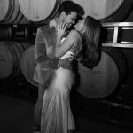 Taylor Lautner Instagram – WELCOME PARTY
Following rehearsal dinner, doors opened to the rest of the underground wine caves where we held a party to welcome all of our guests to Paso Robles for the weekend. Two black wooden bars, grey stoneware plates, charcoal tufted couches and loveseats, and gorgeous concrete and wooden starburst cocktail tables were additional details which enhanced the existing environment, and played into the underground winery aesthetic. We are true foodies at heart so we wanted to give guests an assortment of options to indulge in. This included 4 different food stations to satisfy every palate. A Mezze station, oyster and seafood bar, Tapas station and an Americana station. Our personal favorite was the chef carved Jamoń Iberico and chef manned raclette cheese melter. Complimenting the delicious food of course was Epoch’s killer wines. It truly was the most unique environment and best way to welcome all of our family and friends to a place that holds such a special spot in our hearts.
Let the festivities begin!
Planning and Event Design @samkoma.world
Venue @epochwines
Photography @nicoleivanovphoto
Lighting @tn_event_designs