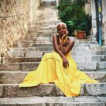 Thuso Mbedu Instagram - My favorite story: My sister was born in April 1989. She was a quiet and sad child. They’d always find her sitting, staring wistfully through the window. She didn’t speak or smile or dance. Then suddenly on the 8th of July 1991 I was born. Her greatest gift. I’m told my sister broke out into song and dance and hasn’t stopped singing. I’m a true light to her which is why I wore yellow today 🥹 My sister (and my family) will deny it but it’s because this is only the first draft😒 don’t listen to em. It sounds better in my head. P.S I lost count on the number of compliments I received on this @farmrio dress 😅😮‍💨 P.P.S Happy birthday to everyone born today. Shout out to my known birthday twins: Bongeka, Amo, Joseph, Mfundo, Craig and Skye🥰 Dubrovnik, Croatia