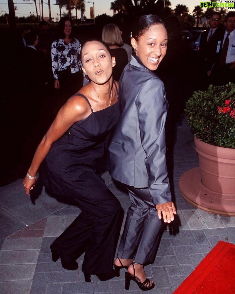 Tia Mowry Instagram - Take two on a trip down memory lane of me and @tameramowrytwo iconic 90’s red carpet looks 💅🏽Fashion is so cyclical, like the leather trench coats, the long skirts, the capris! I feel like I see outfits that are similar all the time on ig nowadays 😂 But I gotta know, which outfits are your favorite 👀
