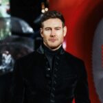 Tom Hopper Instagram - Fantastic evening at the @ferrarithemovie London premiere. Thank you to @johnvarvatos for the outfit 🙌🏼 Which, considering it was made of velvet, was surprisingly quite rain resistant on a ridiculously wet evening!🌧️ @millermode 🙏🏼💙 @breitling_uk @breitling ⌚️ Odeon Leicester Square