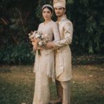 Tyas Mirasih Instagram – Hand in hand. You & me.
Today, tomorrow,forever đź’Ť
Well Organized by : @adara.wedding
Venue @themanorandara
Photography & Videography : @morden.co @samuelrustandy @bychandrasusanto
Decoration & Tents : @classytentdecoration
Carpets : @farahcarpetsofficial
Lighting : @uplightpro
Make Up : @hepidavid
Hair Do : @tominjoo
Bride’s Attire for Akad Nikah & Reception : @svarna_byikatindonesia @didietmaulana
Bride’s Crown & Headpiece @rinaldyyunardi
Jewelry : @adellejewellery
Bride’s Wedding Shoes : @regisbridalshoes
Bride’s robe : @lucette_essie
Bride’s Nail art : @kookoo.nails
Groom’s Attire for Akad Nikah & Reception : @svarna_byikatindonesia @didietmaulana
Bride and Groom textile : @the.designerworkshop
Groom’s Hairstylist : @aryadillah_27
Mother Makeup : @wulanwidianto
Sister Makeup :
@bonitaelisabeth.makeup @belovedbyhepidavid
Wedding Ring : @adellejewellery
Akad Catering :
@teppanku
@baksobuetu
@gococo.indonesia
@ponut.id
@papo_id
@cantikaputricake
Reception Catering : @themanor.cafe
Akad Souvenir : @howelandco
Reception Souvenir : @redribbongift @drzlim_official
Digital Invitation & Live streaming : @viding.co
Mahar & Ring box : @jingga_seserahanmahar
Bouquets : @faveur.florist
Wedding Cake : @sweetsalt_id
Birthday Cake : @RRCakes
Entertainment : @aqisinggih
Sound system : @deoentertainmentindonesia
MC Akad & Reception : @andrakarna
Usher : @beauty_usher
Photobooth : @theholograil
Gift : @farahcarpetsofficial
@bardismarthome
#TEZIapbahagiainTYAS The Manor Andara