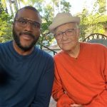 Tyler Perry Instagram – Not long ago I had the pleasure of meeting one of my heroes. He invited me to lunch at his home and as we sat and talked and laughed, I got a chance to tell him how he had helped save my life. I shared with him that he taught me to dream a bigger dream by his example.  He was 100 years old at the time, but sharp as ever. Full of wisdom and great advice, and I took it all in.  Just before I left, I asked, “At 100 years old what are you looking forward to?”  Without any hesitation he said, “Tomorrow.”  It was such a simple but powerful lesson to live your life fully one day at a time. And One Day at a Time just happened to be the name of one of his many hit TV shows along with Maude, All in The Family, Good Times, Sanford and Son and so many other incredible shows. They were the only thing that brought laughter and joy to me as a child, who was living a daily nightmare. I’m so glad that I had the chance to say to him, thanks to his vision and his work, he gave me many “tomorrows” to look forward to. So today, sadly, I say goodbye and I salute a veteran. One who asked me to help put  together a moment for him to say thank you to the surviving Redtail Tuskegee Airmen, he wanted to thank them for the escorts they provided him and others during World War II, which I did with Robin Roberts on GMA. It felt good to be able to do something for him. 
 
A hero and someone who inspired me to try and bring as much laughter to the world as he bought to the little boy that I was. You sir are truly one of one!  I’m so glad we were on the planet at the same time. Thank you for your example. Rest in peace my dear friend, I thank God for you. My prayers are with your family. 
Travel well, Mr. Norman Lear.