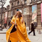 Tyra Banks Instagram - As a teenager, I walked the streets of Paris, going from casting to casting, hoping to get chosen. Cut to decades later… Moments after the @louisvuitton x @kidsuper men’s fashion show, and I have no shame in getting my pose on in front of the @museelouvre rocking a Louis cap Colm gave me and a golden kaftan I picked up from an Abu Dhabi desert hotel gift shop. Every #Paris street is a photo studio. Remember that. 💪🏽🇫🇷📸