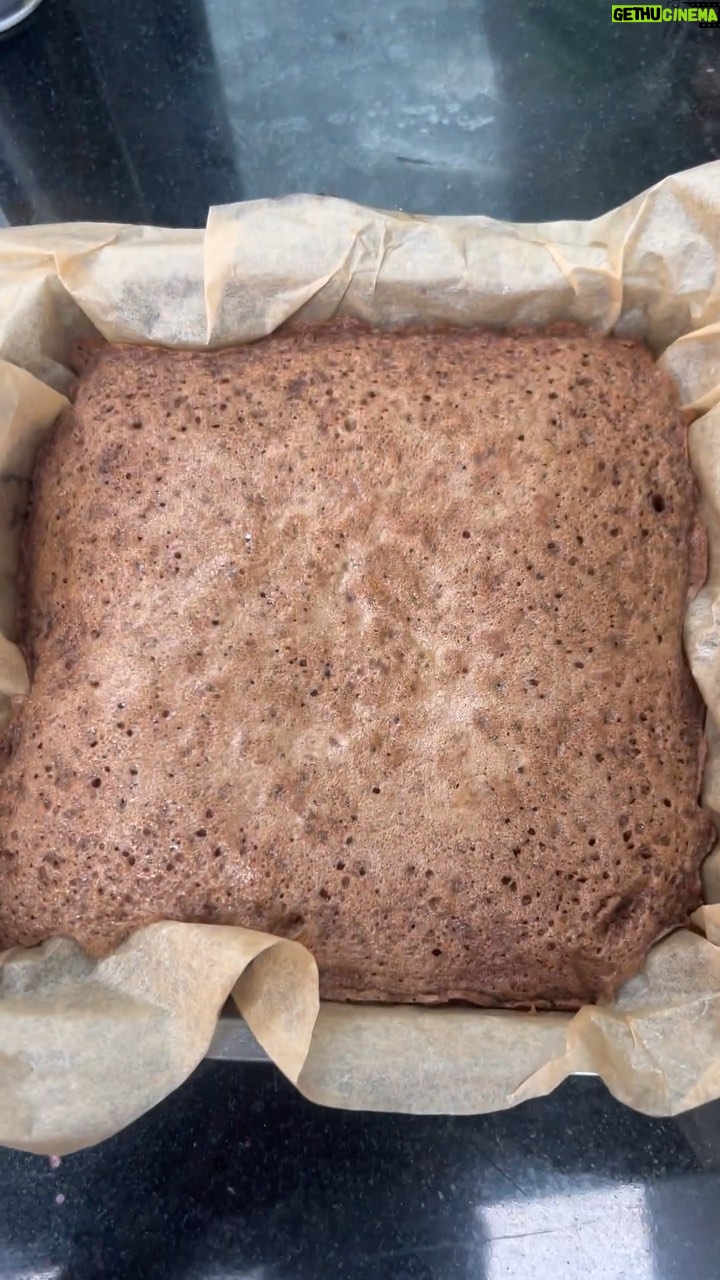 Vikas Khanna Instagram - I swear this is going to be your next favorite chocolate cake. You do not temper the chocolate, it means with the warm butter. And also adds texture to the cake. - 1 cup high-quality dark chocolate - 1 cup unsalted butter (2 sticks) - 3/4 cup granulated sugar - 4 large eggs - 1 teaspoon vanilla extract - 1/2 cup all-purpose flour - Pinch of salt Instructions: 1. Preheat your oven to 350°F (180°C). Grease a square cake pan and line it with parchment paper. 2. Melt the butter using a microwave for 2 mins on high and pour it over sugar. Add the chocolate and mix well. 3. Add vanilla extract, eggs and whisk until the mixture becomes light and fluffy. 5. Sift in the flour and add a pinch of salt, then fold until just combined. Be careful not to overmix. 6. Pour the batter into the prepared cake pan with parchment paper and tap on the counter for a smooth top. 7. Bake in the preheated oven for about 25-30 minutes or until a toothpick inserted into the center comes out with moist crumbs. 8. Allow the chocolate cake to cool in the pan before transferring it to a serving plate. Save & Share. New York, New York