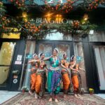 Vikas Khanna Instagram – Today we had an amazing prayer dance to honor the land on which Bungalow is built. 

The dance begins with Odissi’s trikhandi (three-fold) pranam seeking the blessings of Mother earth (the ancient ritual of bhoomi pranam), the gods, gurus and seniors.

Performances by Surati for Performing Arts choreographed and led by Founder and Artistic Director Rimli Roy. 

Indian dance movements based on Odissi classical dance from the State of Orissa characterized by its subtle torso movements, asymmetrical stances like tribhangi made of three body bends and fluid wristwork. 
Surati company dancers included Reba Browne, Jeevika Bhat, Tanvi Chandak and Annie Renita. 

8 Days To Go…