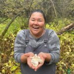 Alexis Nikole Nelson Instagram – Happy #indigenouspeoplesday to all of the indigenous land and water protectors, culture and language preservers, colonization resisters, who exemplify what land stewardship could and should look like worldwide.
This weekend the @prairieislandindiancommunity hosted @linda.black.elk, Sam Thayer, @mnforager, and @foragerchef, and I. we got to partake in harvesting Wapato, Sagittaria latifolia (some of the elders grew up calling them Rat Potatoes after the muskrats that also enjoy them! And though i think I’m spelling it wrong, it’s Dakota name psį́n ćiŋćá or child of the rice is both botanically accurate as many were growing beneath stalks of wild rice AND IT IS JUST AN ADORABLE NAME 😭❤️)
The act of gathering and talking and laughing and getting muddy together was truly heart and mind medicine that I didn’t realize I needed. We aren’t built to forage and survive alone ❤️
Thank you so much @nmbuckss and @prairieislandindiancommunity for welcoming me with the warmest hearts, thank you @linda.black.elk and Luke Black Elk for ALWAYS teaching me so dang much and for celebrating with me when I FINALLY found my first tuber (which is why I look so silly and giddy in that first pic!! 😆) Also FCK CHRISTOPHER COLUMBUS ☺️ Prairie Island Indian Community