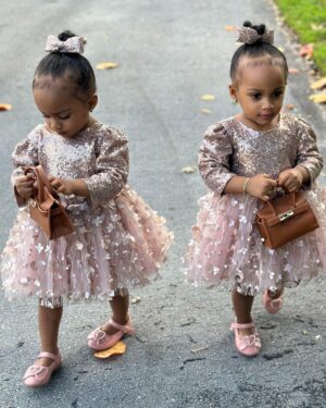 Amara 'La Negra' Instagram - My Little Ladies!  @lasroyaltwins So Bougie with There Babies Hermes Purse from @coolkidznyc I’m so In love with them.. Enamorada de Mis Bebés 👧🏽👧🏽 #SumajestadRoyalty #SualtezaEmpress 
Dress; @rubybellebaby