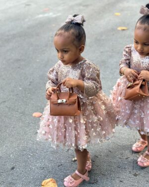 Amara 'La Negra' Instagram - My Little Ladies!  @lasroyaltwins So Bougie with There Babies Hermes Purse from @coolkidznyc I’m so In love with them.. Enamorada de Mis Bebés 👧🏽👧🏽 #SumajestadRoyalty #SualtezaEmpress 
Dress; @rubybellebaby