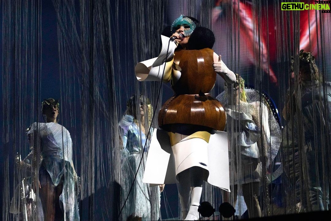 Björk Instagram - thanks for tonight Leipzig! musicians : @viibraflutes @bergurth @manudelagomusic @katiebuckleyharpist bjork wood sculpture outfit @zomer.official @xylomancia_ dress @kwkbykaykwok headpieces @james.t.merry sphæra dress @irisvanherpen musicians outfits @balmain hair @johnvialhair musicians hair @tomikono_wig makeup @isshehungry styling @eddagud photos @santiagraphy Leipzig, Germany