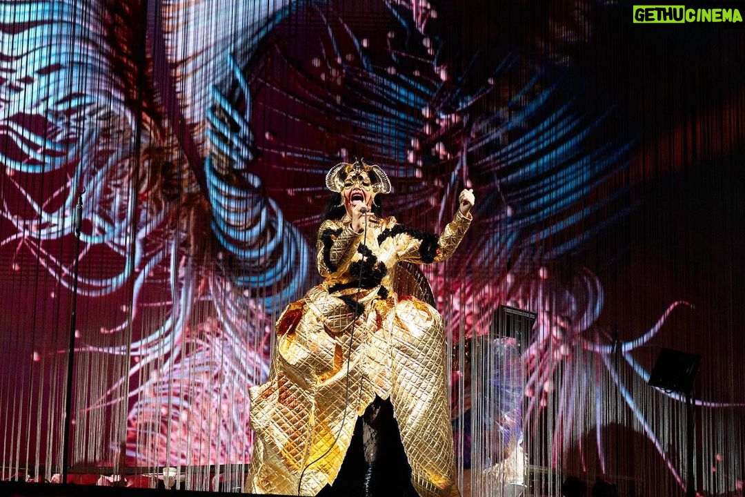 Björk Instagram - thanks for tonight prague! musicians : @viibraflutes @bergurth @manudelagomusic @katiebuckleyharpist bjork outfit @babbym headpieces @james.t.merry boots @driesvannoten sphaera dress @irisvanherpen musicians outfits @balmain hair pieces @tomikono_wig makeup @isshehungry styling @eddagud photos @santiagraphy Prague, Czech Republic