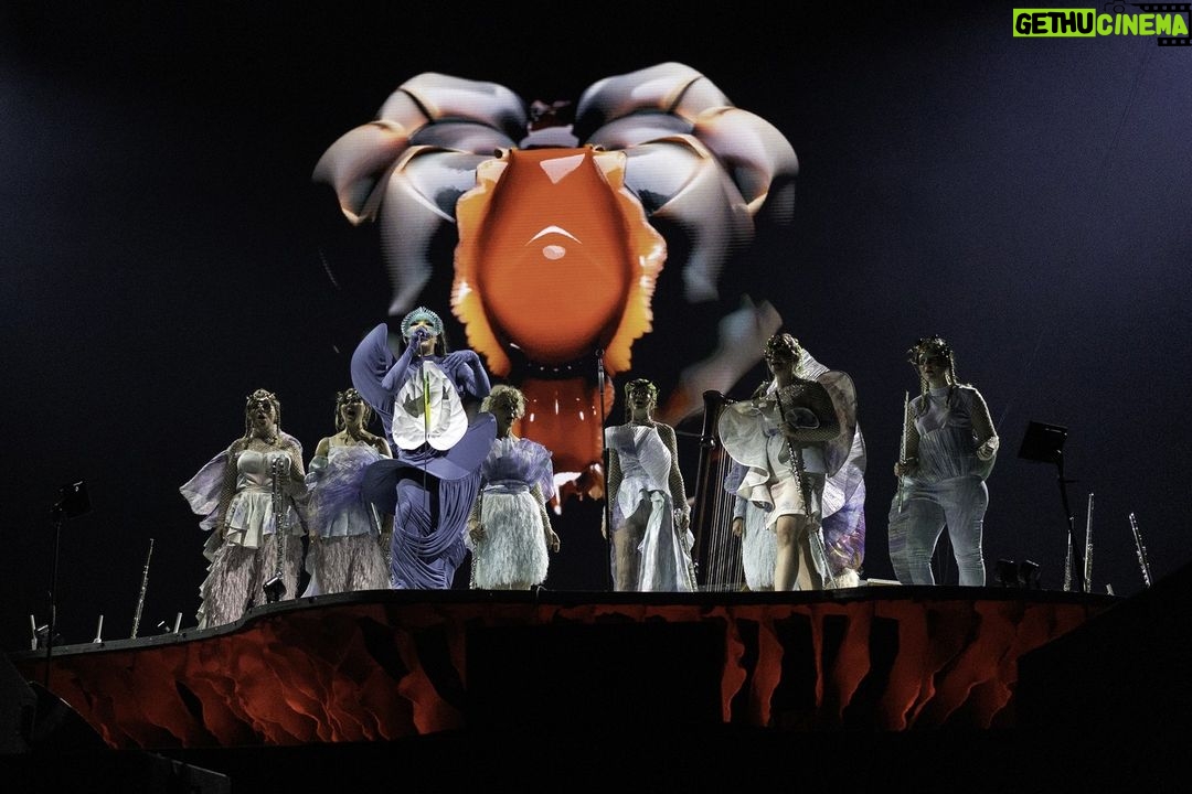 Björk Instagram - thank you paris for a spectacular evening ! musicians : @viibraflutes @bergurth @manudelagomusic @katiebuckleyharpist bjork dress @jisoobaikparis anthurium flower @loewe headpieces @james.t.merry shoes @maisonmargiela encore outfit @irisvanherpen musicians outfits @balmain hair pieces @tomikono_wig makeup @isshehungry styling @eddagud photos @santiagraphy